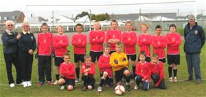 Rotary Club of Cowes President Anna Morgan-Crockett & Rotarians Barry Myland & Brian Saunders with the Under 12's in their new kit.