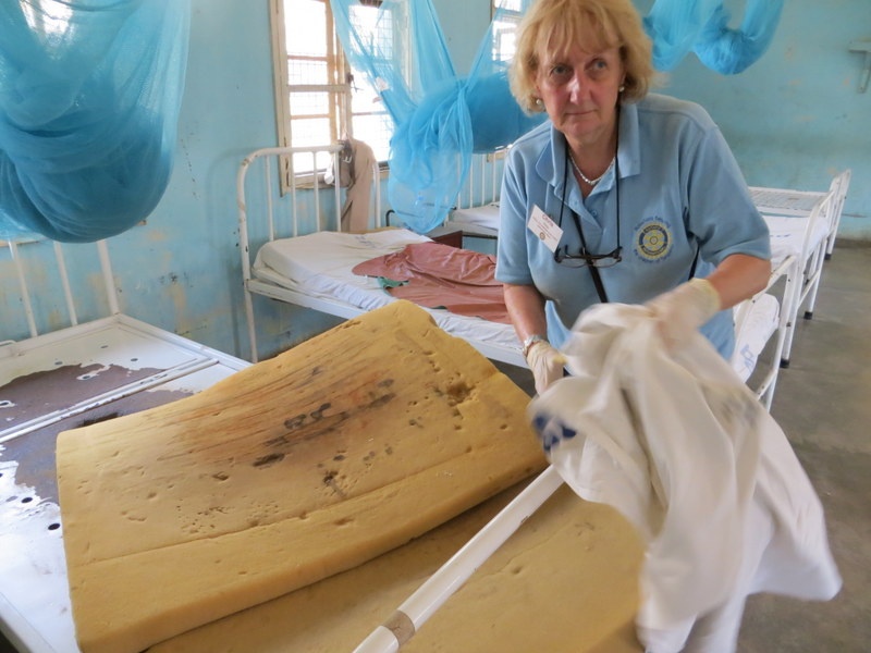 Nurse having use soiled bedding for next patient.