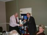 President David presents Bob with a gift from the Club