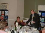 Bob's wife, Gaynor,  receives bouquet flowers from President David