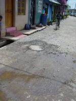 PROGRESS: Road in has new chippings, better gutter & manhole of new sewer