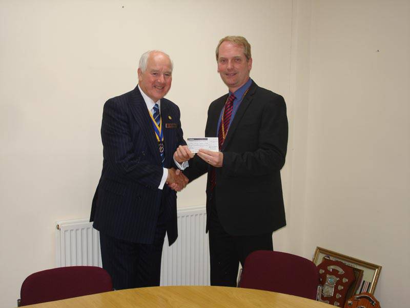 Past President Martin Middleton presenting the cheque for the Refilwe Project to Mark Rodaway, Headmaster of Calday Grange Grammar School