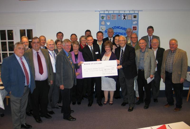 Club members with Strathcarron's Billy Andrew and Marjory Mackay accepting cheque from President Iain Smith and Dunblane New Golf Club Captain, Alan Crockett