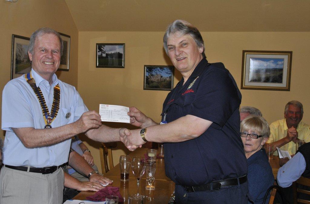 Dinner and First Responders speaker at the Baron - President Patrick presenting our donation to Ian Owen