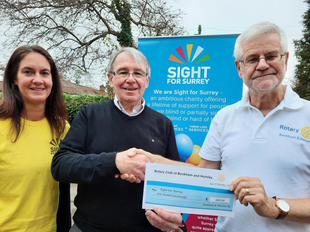 Rotarian Barry Davies presenting our cheque to Bob Hughes, Chief Executive and Lisa Fletcher from Sight for Surrey.