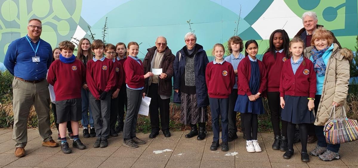 Rotakids with representatives from the educational arm of PONT receiving  a cheque of £414.95 from President April