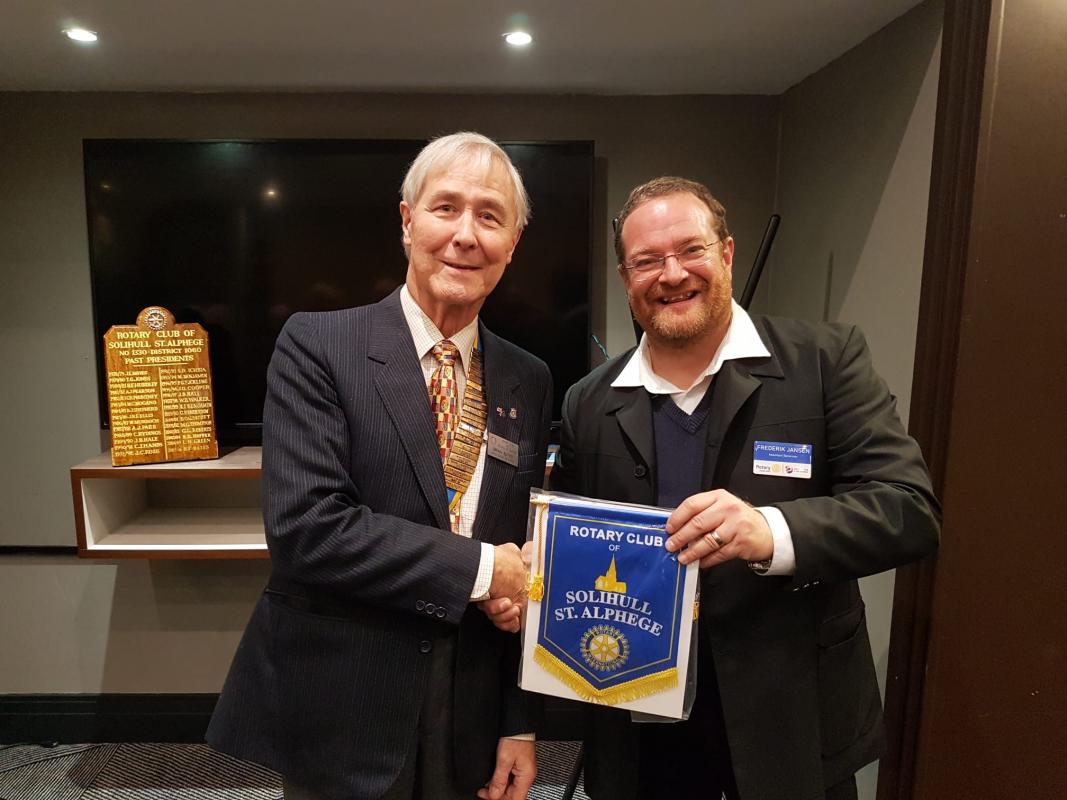 President Brian Bates presents a banner to AG Frederik Jensen. 