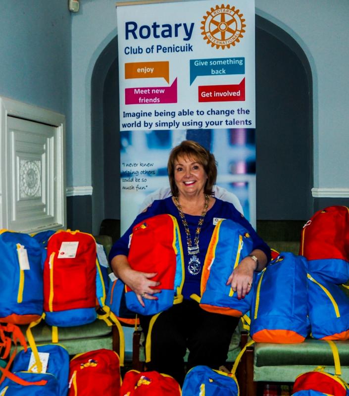 President Rhona Somerville with some of the filled back packs.