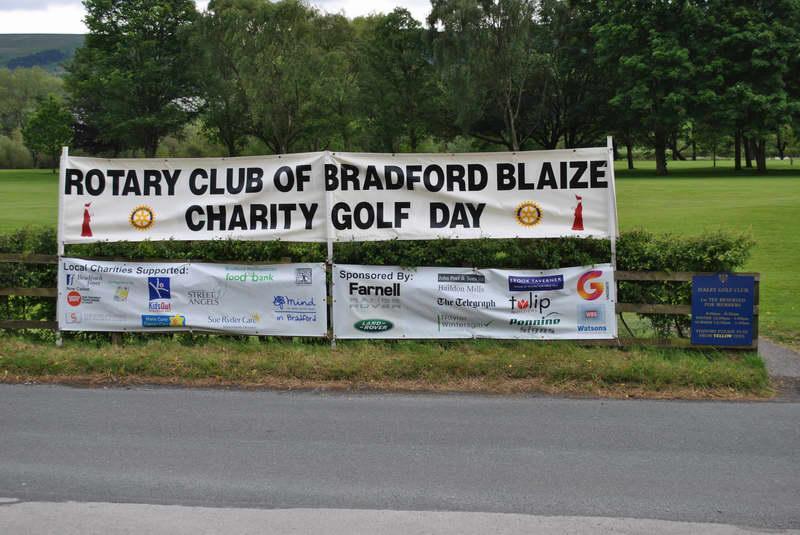 25th Annual Charity Golf Tournament - A photograph of Ilkley Golf Course with the sponsors names on one banner and the charities supported on the other