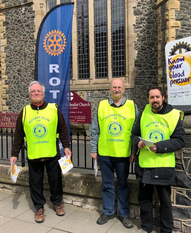 Rotarians Chris Drew Steve Butler and Ray Khan form an unlikely group of medical auxiliaries as they invite passing members of the public to have their blood pressure tested by Dr. Ashok Harshey and his team