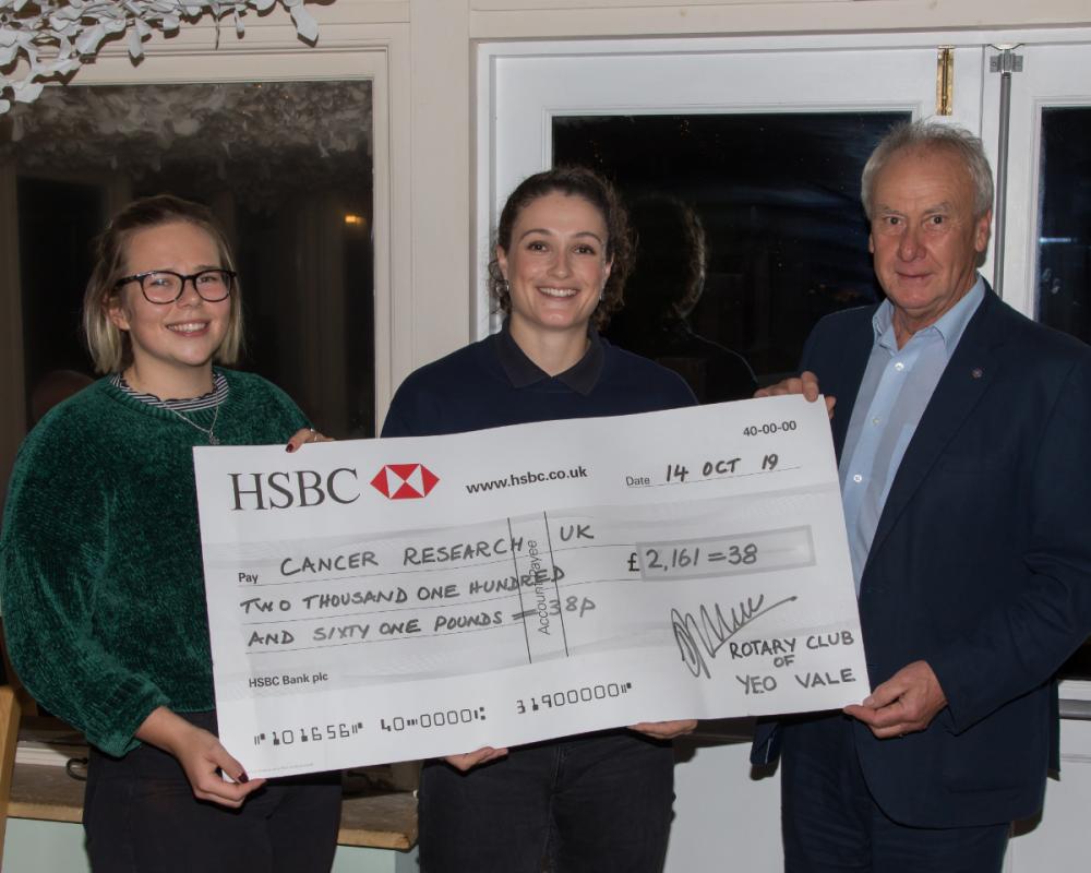 President Phil handing a cheque to Becky Trout of Cancer Research UK