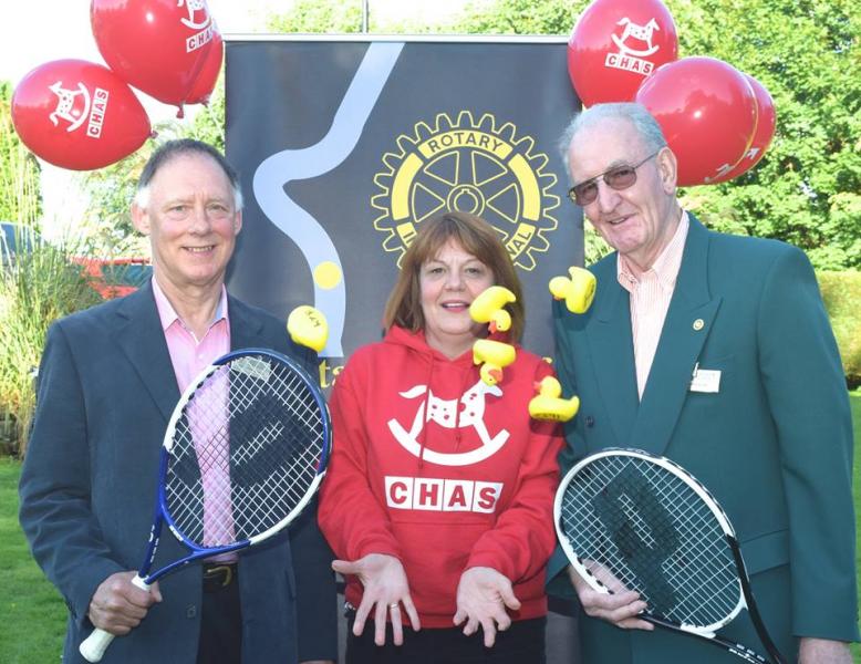 Alison Rennie, Fund Raiser for CHAS, throws up a handful of Duck Race competitors, with Nick Rawlings, President Elect of Bridge of Allan and Dunblane Rotary Club (left) and John Kilby, Chairman of the Club