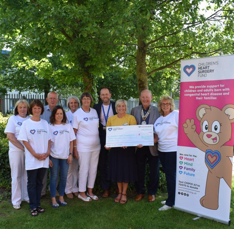 Keeping The Beat target reached - Cheque presentation with some of the people who worked so hard to raise the money:- L to R – Judith Evans, Jill Brookling, Neil Dodgson, Charlotte Woods, Rosemary Pugh, Elaine Dodgson, Andy McNally, Lisa Williams, Dick Wood and Maggie Ablitt