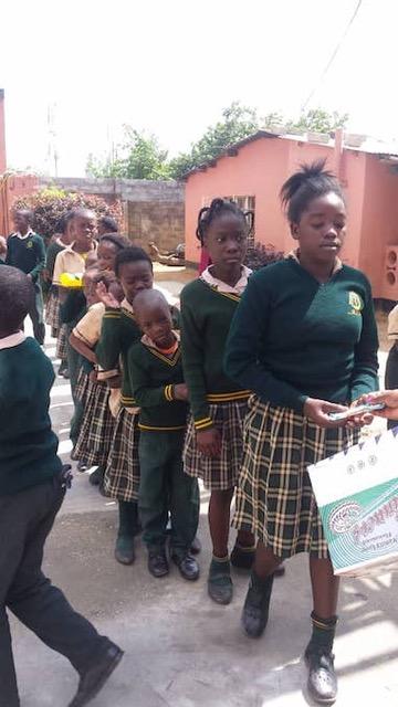 Children receiving food parcels in Lusaka