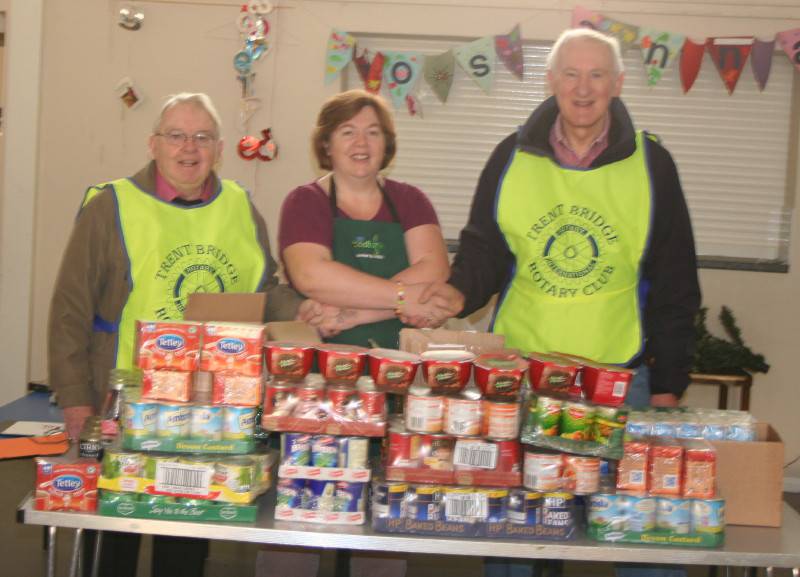 Rotarians Frank Matthews and Adrian Whiteside with Clifton Food bank manager Wendy.