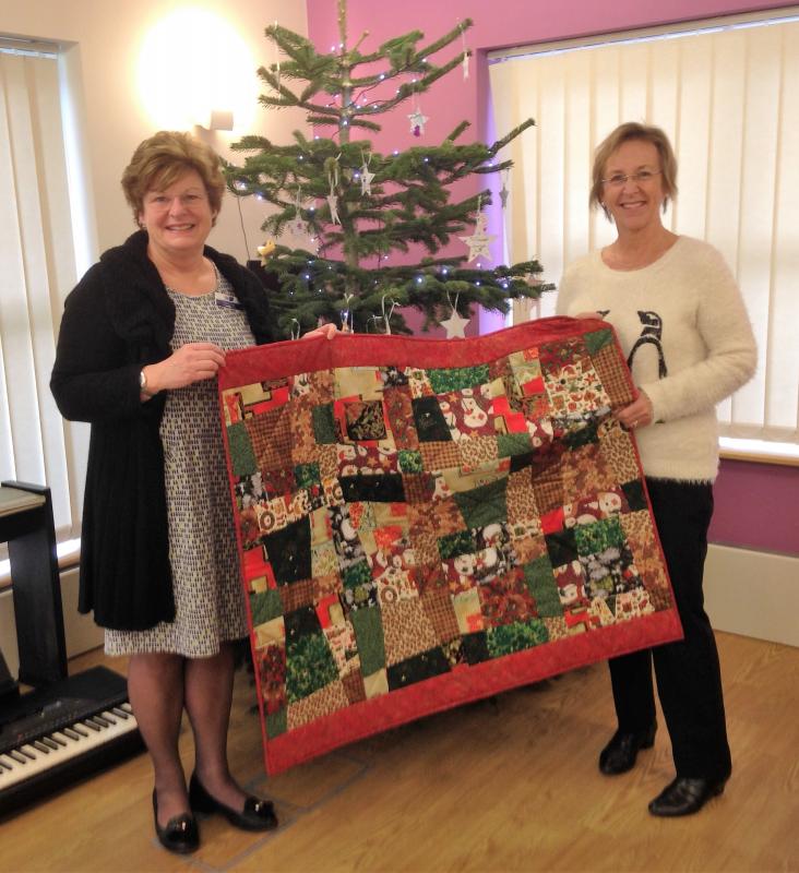 Quilt maker Mary Rawlins with Garden House Hospice's Helen Clark