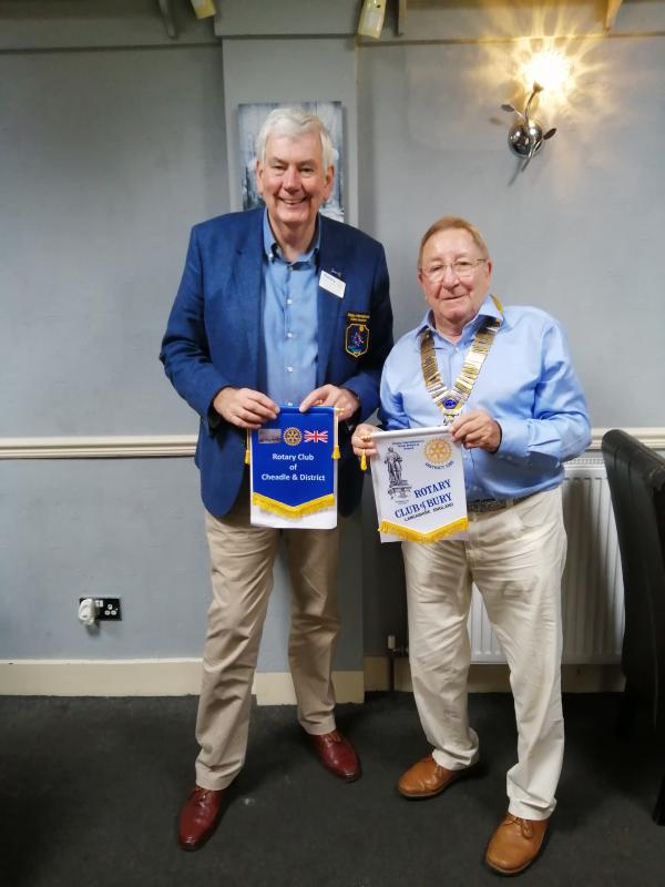 DG Patrick Tyrrell and Bury Club President John Cooper are about to swap Club Banners