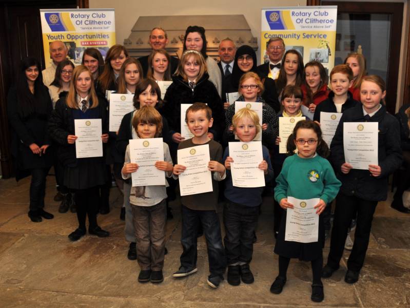 Young Artist & Young Photographer Clitheroe Area Prize Winners with Rotarians from the organising Committee at back - right to left: President David Openshaw, Graham Claydon & Philip Naylor 