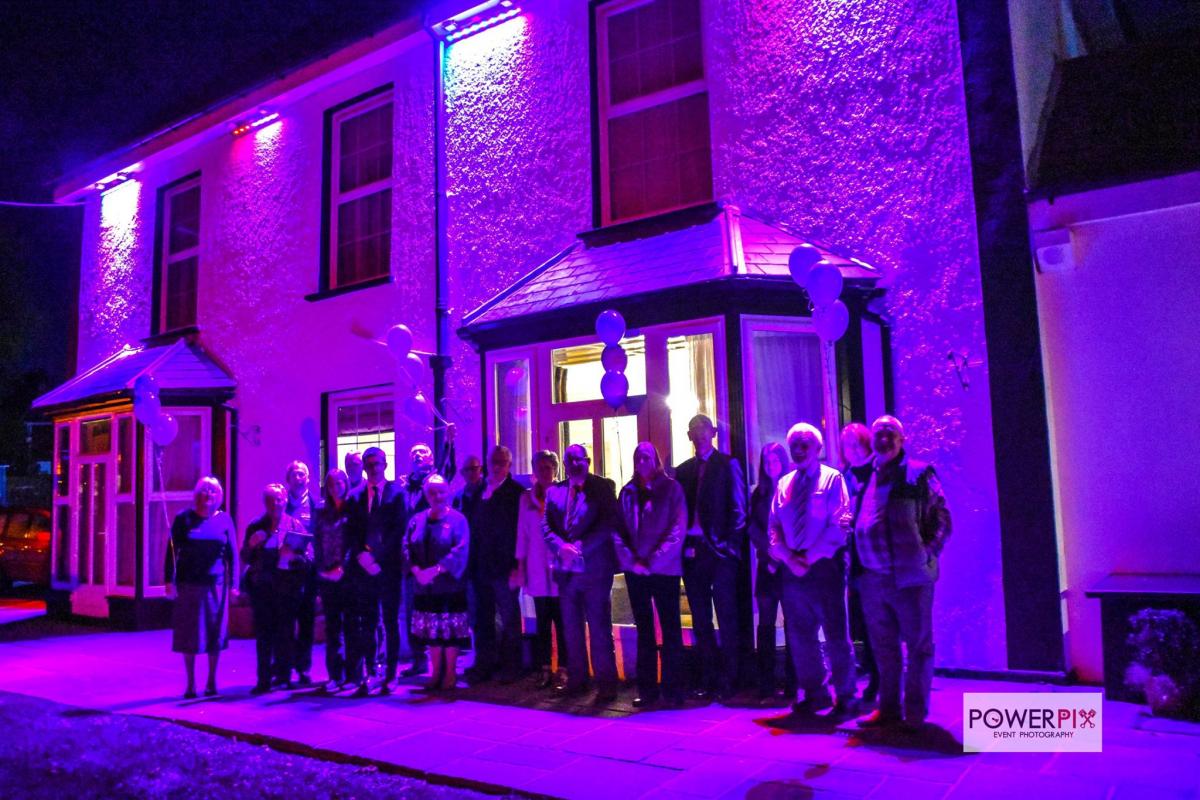 Rotarians and friends outside the purple floodlit Plas Hyfryd Hotel, Marberth.