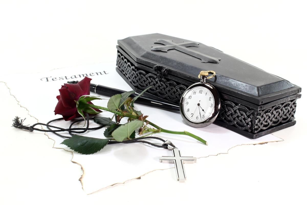 Model coffin, with a pocket watch and a single rose.
