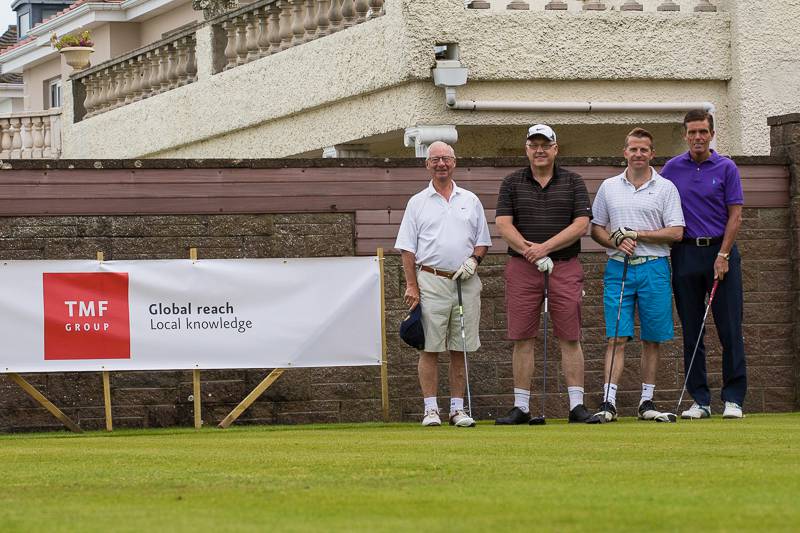 2014 Rotary Charity Golf Day sponsored by TMF Group. - The top fourball ready to tee off down the 1st at the Royal Jersey Golf Club.
