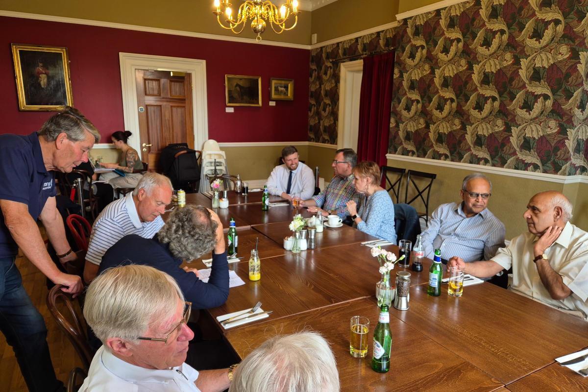 People sitting around a long polished table.