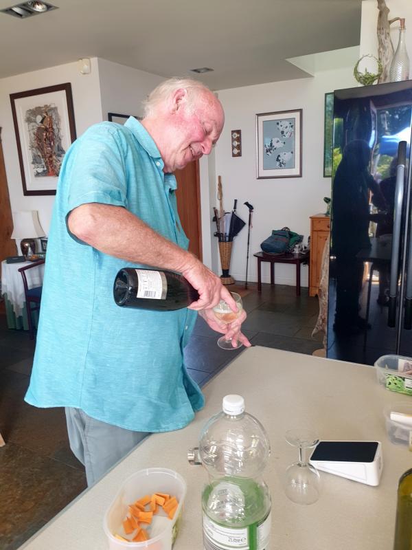 Host Kim pouring a glass of bubbly