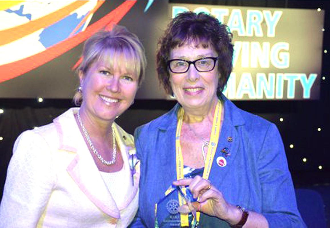 Past President Gill Norton accepts the trophy from Rotary International  Vice-President Jennifer Jones