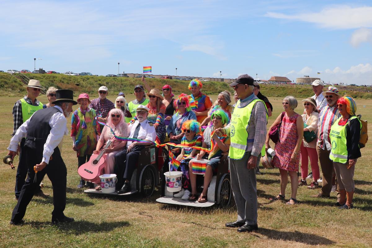 Town Crier Peter White cutting the ribbon at the start of the RAINBOW Walk

