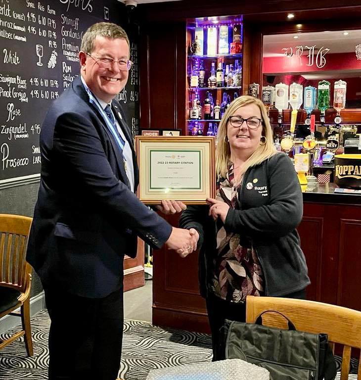 Immediate Past District Governor Duncan Collinson presenting the Rotary Citation to President Paula