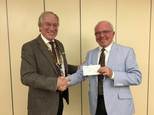Retired Airline Captain, Cyril Mannion, accepts a cheque for £100 on behalf of Wiltshire Air Ambulance from President Frank.