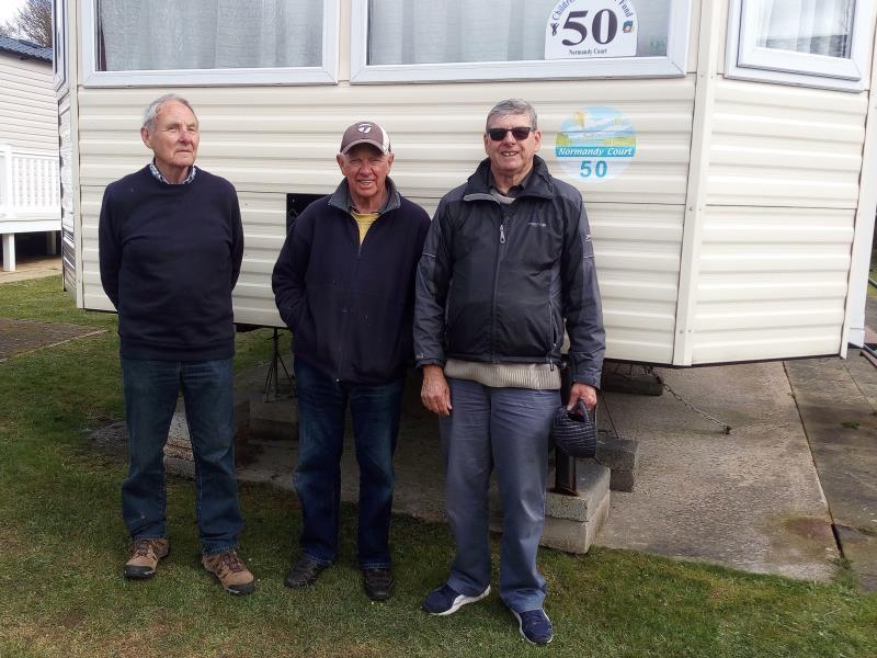 Three of the cleaning crew outside the caravan