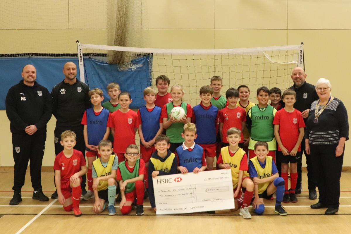 Member of Seaford Football Club Under 11 squad with on the left coaches Michael Greve and Grant Gerrish and on the right coach Steve Broach and President Ann Reed
