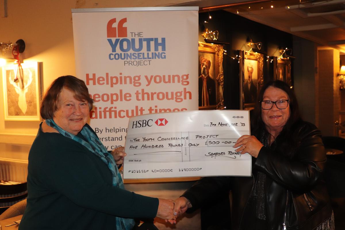 President Mandy Davis presenting the donation cheque to Julia Hancock, Chair of Trustees for The Youth Counselling Project