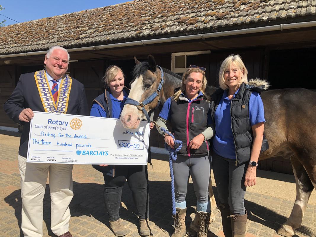 President Paul Kunes presenting a cheque for £1300.