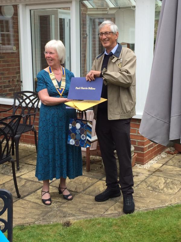President Ann receiving a Paul Harris Fellowship from President Elect Peter Chandler at her Presidents at Home, June 2021