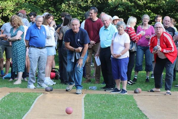 Vice President Mike Barker bowling his first ball watched by Bill Pierce and Frank and Ivy Thompson