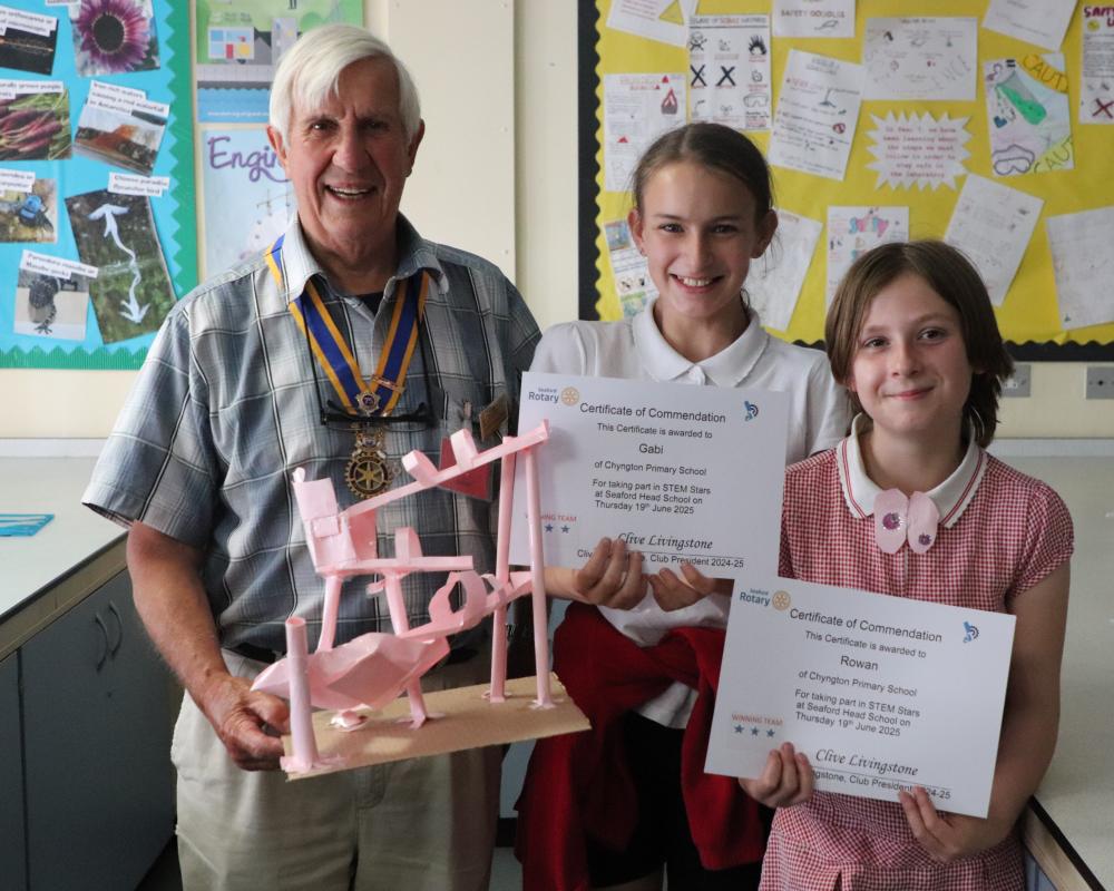 President Clive Livingstone holding the winning construction with Rowan and Gabi ,two members from the winning team from Chyngton Primary school