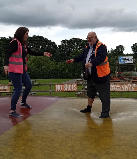 Rev Paul Frostick attempts the bouncy matress.