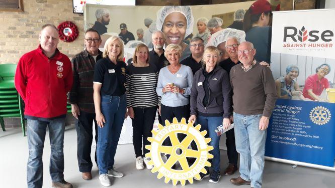 Club members and their partners at the end of the Meal Pack event at Glossopdale School on 14th April 2019 having helped reach the target of 60,000 meals