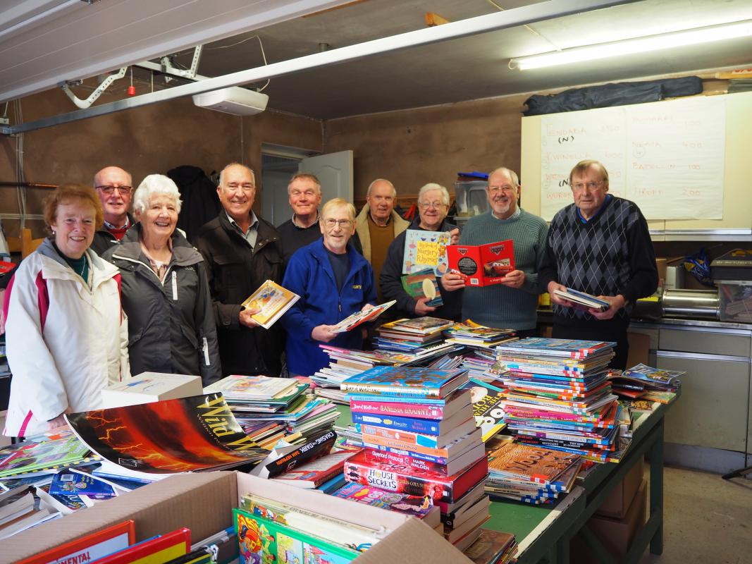 The pile of books to be sorted and packed