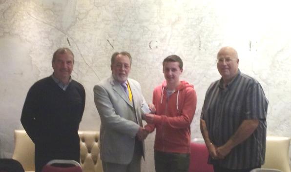 Photograph of cheque for £2000.00 being presented to Tom Haynes of Holyhead Hotspur FC Youth Section.
