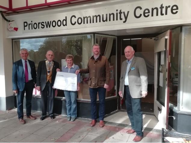 Priorswood Community Centre Manager, Lesley receiving a cheque from President Peter Ball