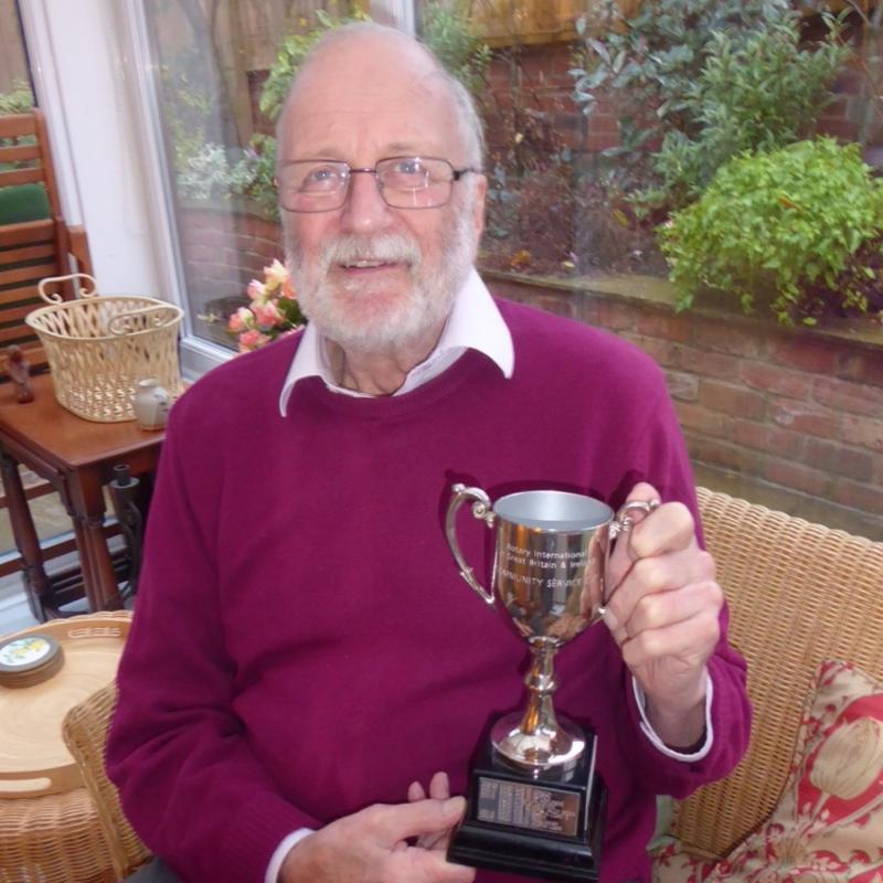 President Peter receives the Community Cup (via post due to COVID) and displays it to the Club members at a Club Zoom Meeting