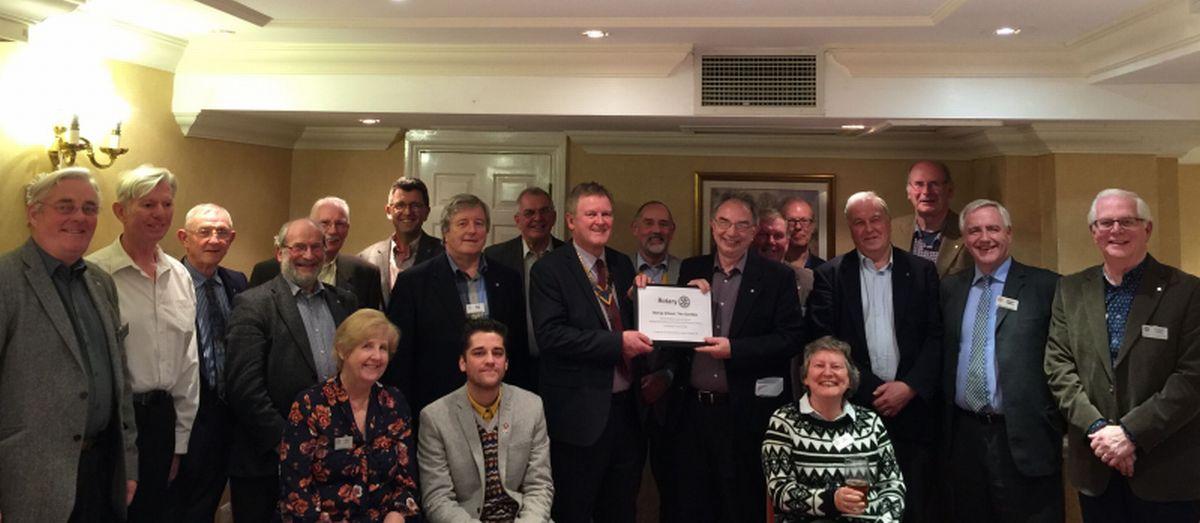 Members with a copy of the plaque which will be displayed in the completed Dining Room at the Bonsa School.