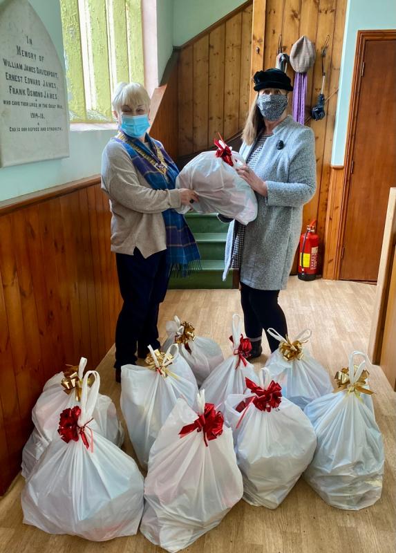 President Margaret Thorp and Helen Anderson with Christmas Hampers 3.12.21