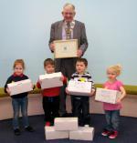 2012 Rotary Shoebox Appeal achieves a total of 2021 Shoeboxes - President Mike Kimpton with some of the young supporters