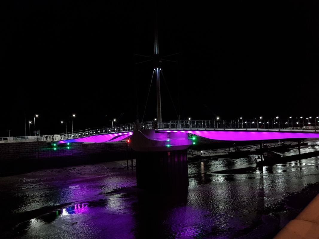 Pont y Ddraig Footbridge lit in purple for World Polio Day