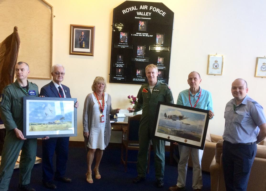 Rotary visit to RAF Valley - Squadron Leader Nick Jewsbury and his guests Two prints for the Officers’ Mess, presented by President Rosalind Hopewell