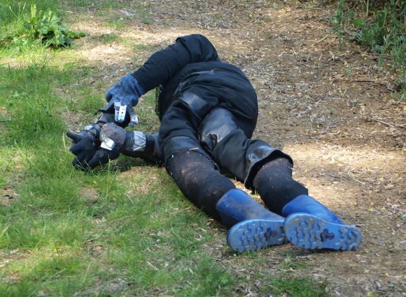 A blue-clad dummy lying on a path